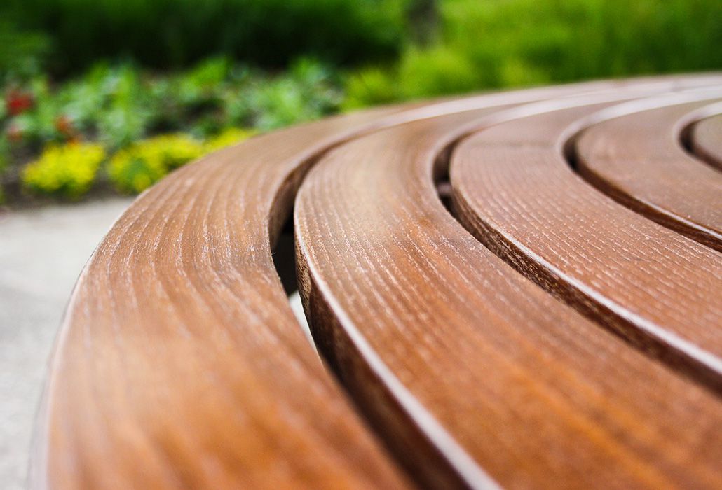 Curved wooden bench made of native woods such as oak, larch and Douglas fir