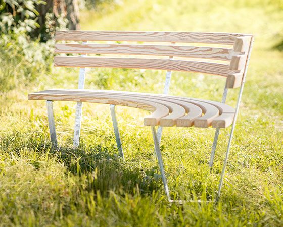 A wooden bench, curved, beautiful and colourful